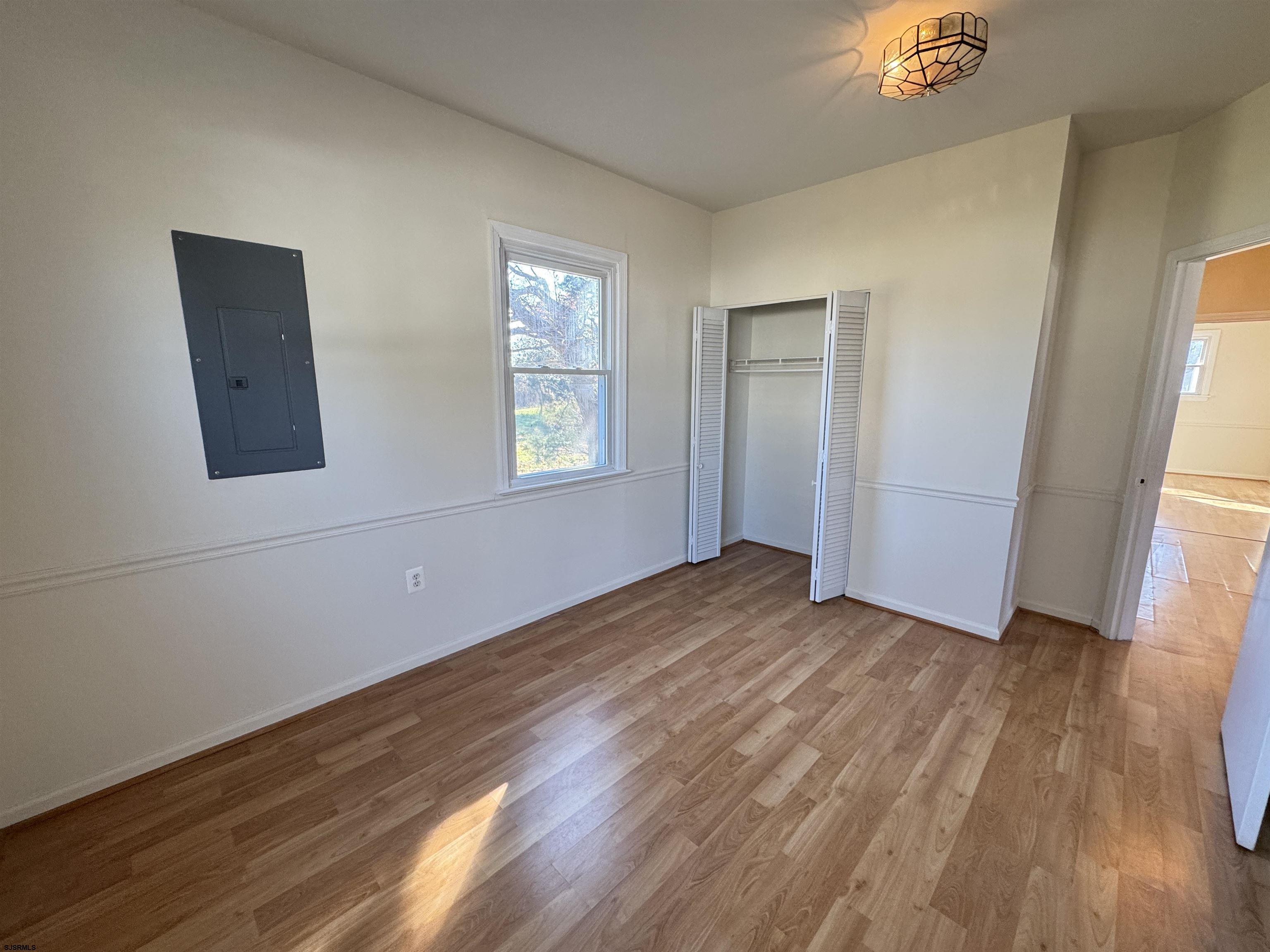 106 Harbor Road Marmora, NJ 08223 - Photo 4 of 11 a view of an empty room with wooden floor and a window