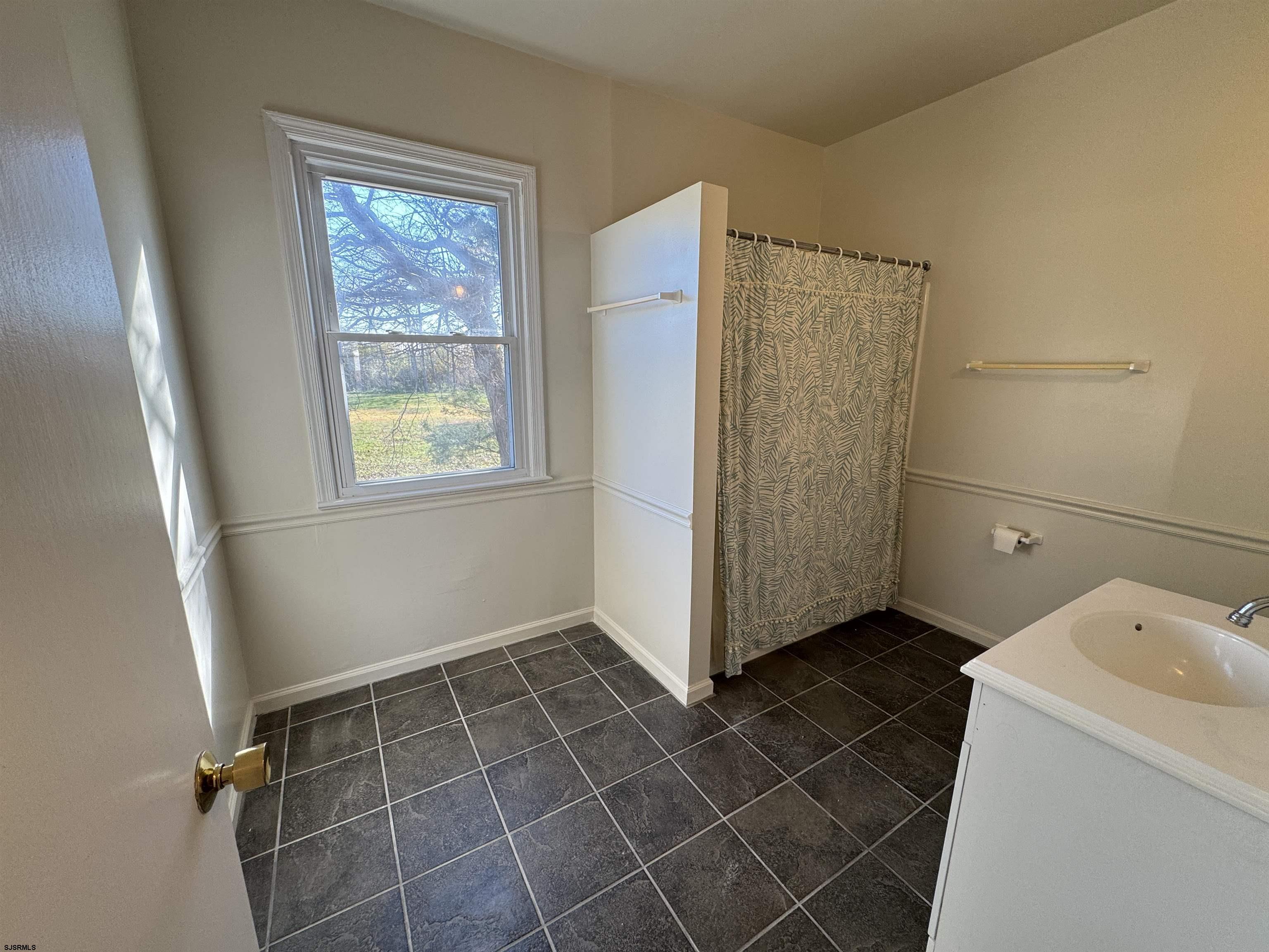 106 Harbor Road Marmora, NJ 08223 - Photo 5 of 11 a bathroom with a sink and a shower