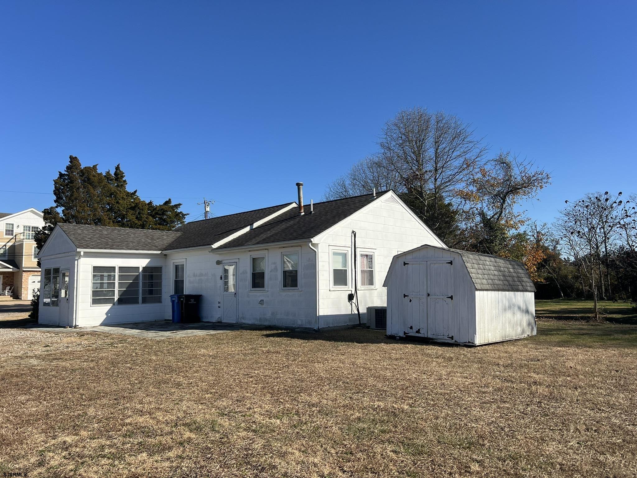 106 Harbor Road Marmora, NJ 08223 - Photo 7 of 11 a view of a house with a yard and large tree