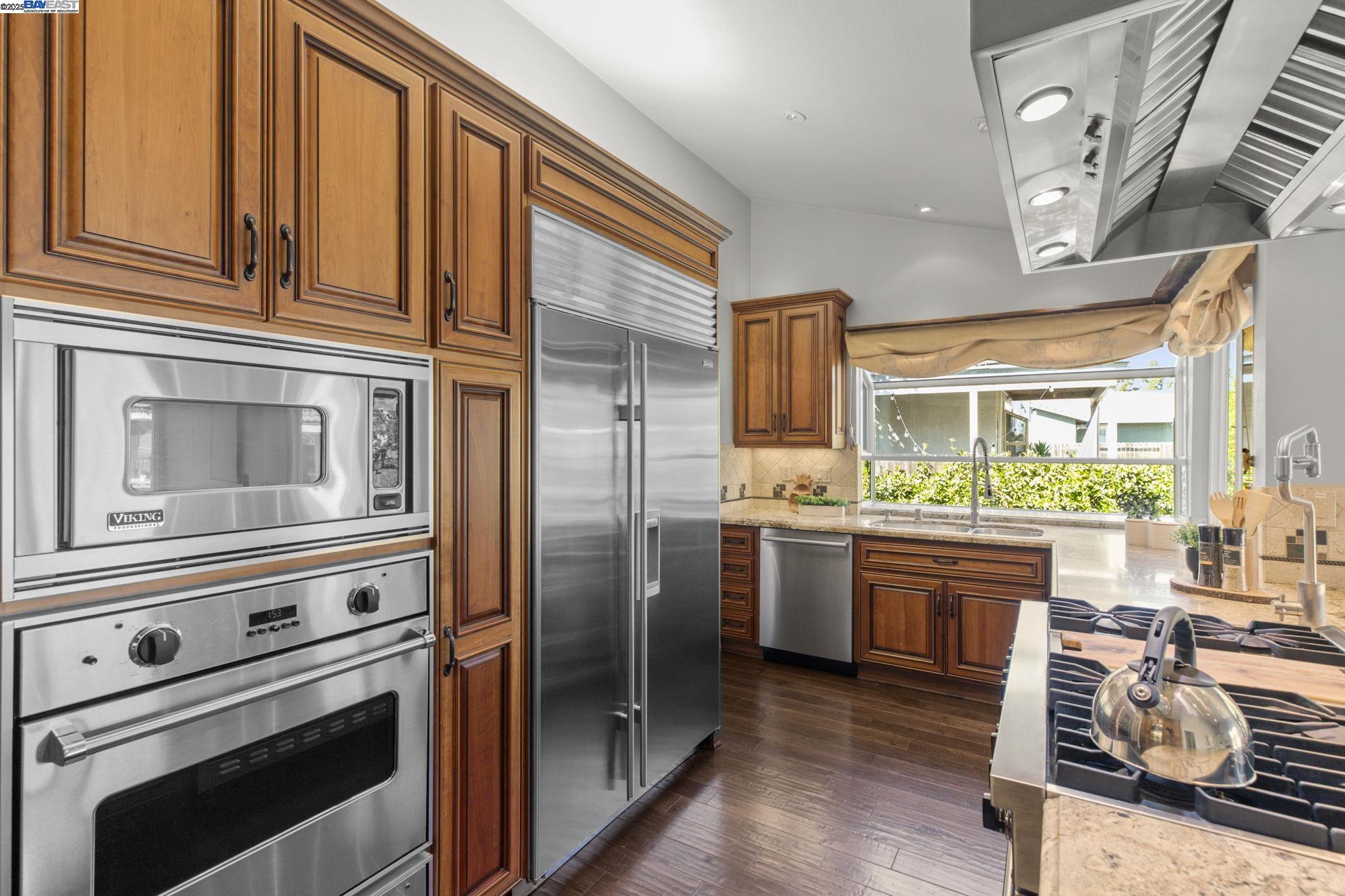 820 Pinehurst Place San Ramon, CA 94583 - Photo 13 of 54 a kitchen with stainless steel appliances granite countertop a refrigerator and cabinets
