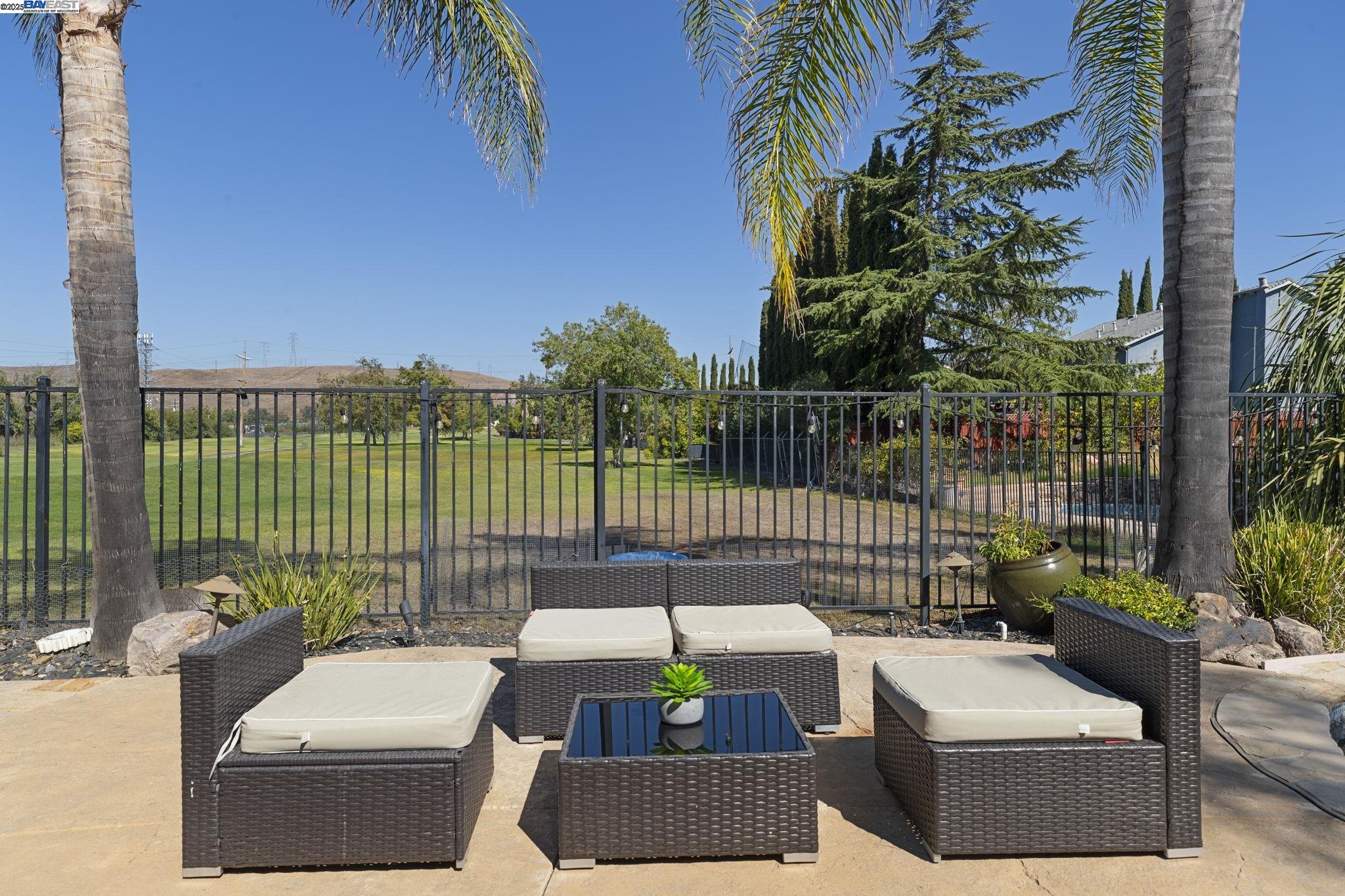 820 Pinehurst Place San Ramon, CA 94583 - Photo 43 of 54 a view of a patio with couches and a table and chairs with wooden floor and fence