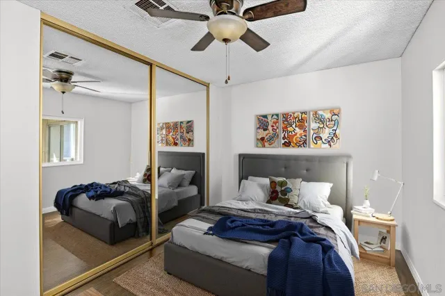 a bedroom with furniture and a ceiling fan