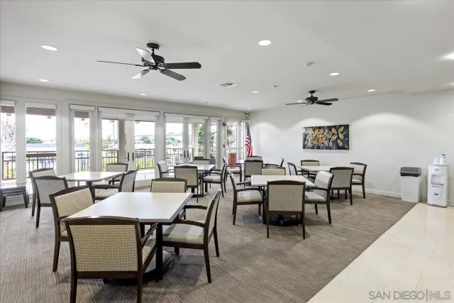 a dining room with furniture a rug and a large window