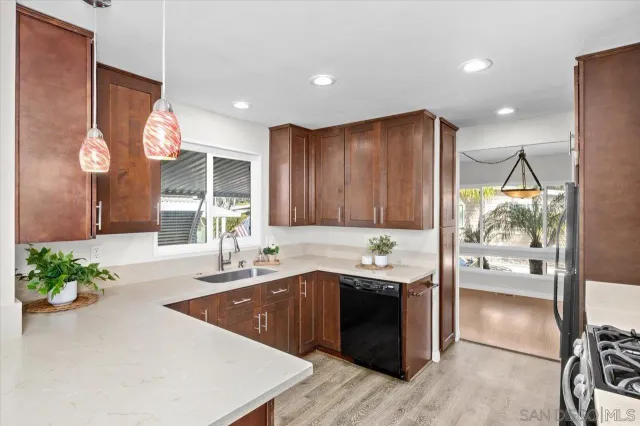 a kitchen with a sink a stove and cabinets