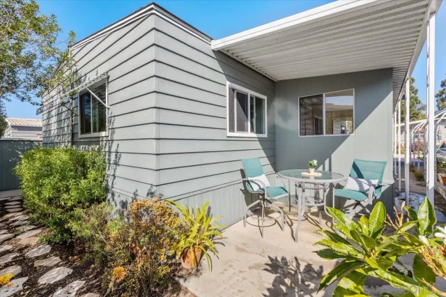 a view of a patio with table and chairs and potted plants