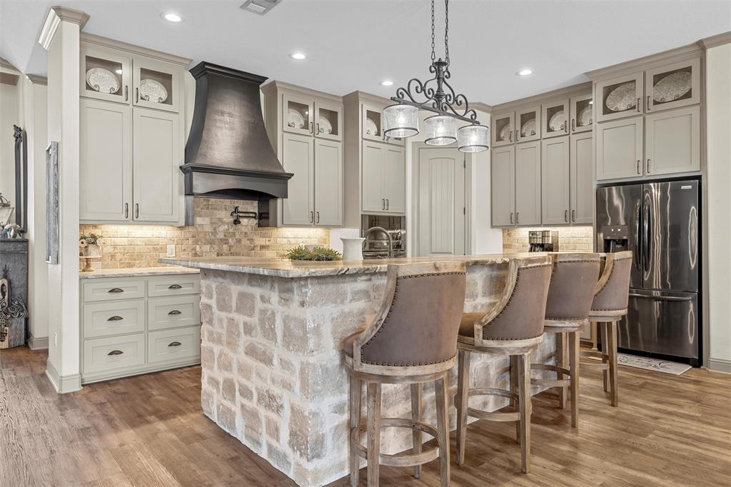 18503 Wortham Bend Road China Spring, TX 76633 - Photo 10 of 40 a dining table with chairs and cabinets