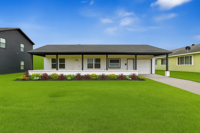 a front view of a house with a garden