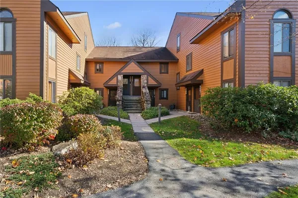 a front view of a house with garden