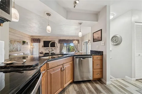 a kitchen with sink stove and refrigerator