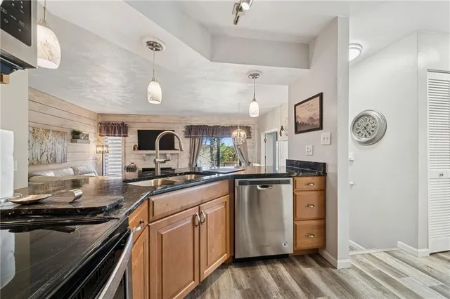 a kitchen with sink stove and refrigerator