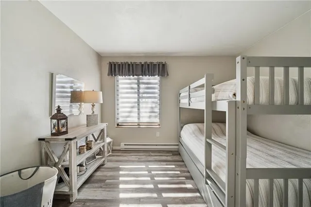 a spacious bedroom with a bed and a window