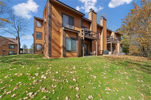 a view of a yard with large trees