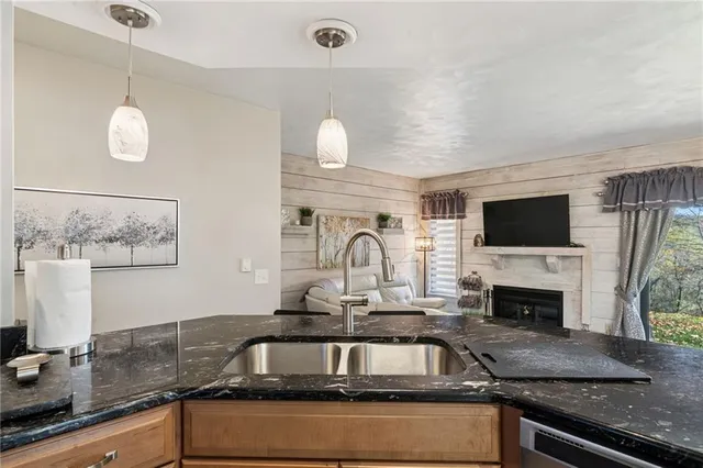 a kitchen with granite countertop a stove and a sink