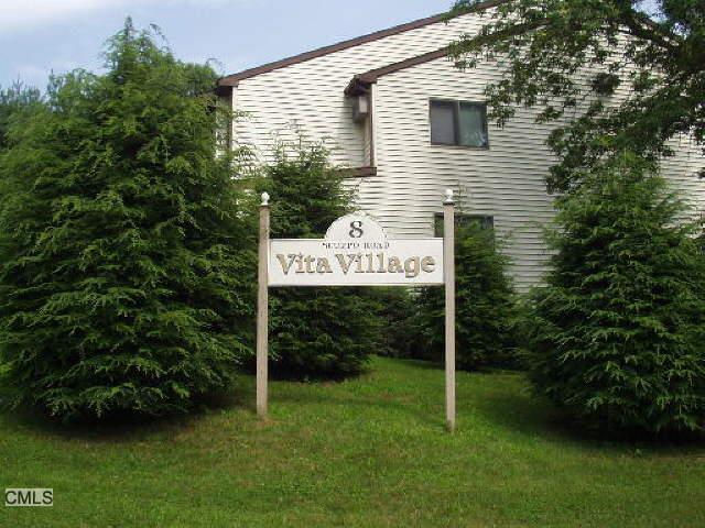 a sign that is sitting in front of a house