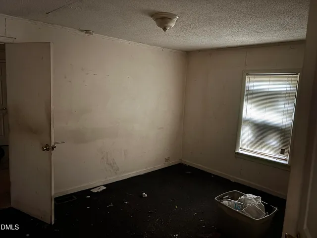 a room with a fireplace and a window