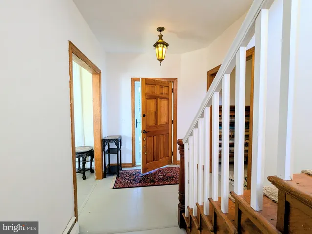 a view of an entryway with wooden floor
