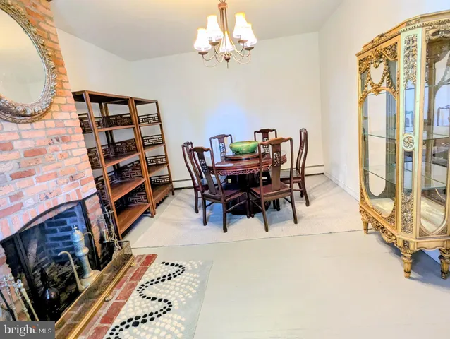 a view of a dining room with furniture and a chandelier