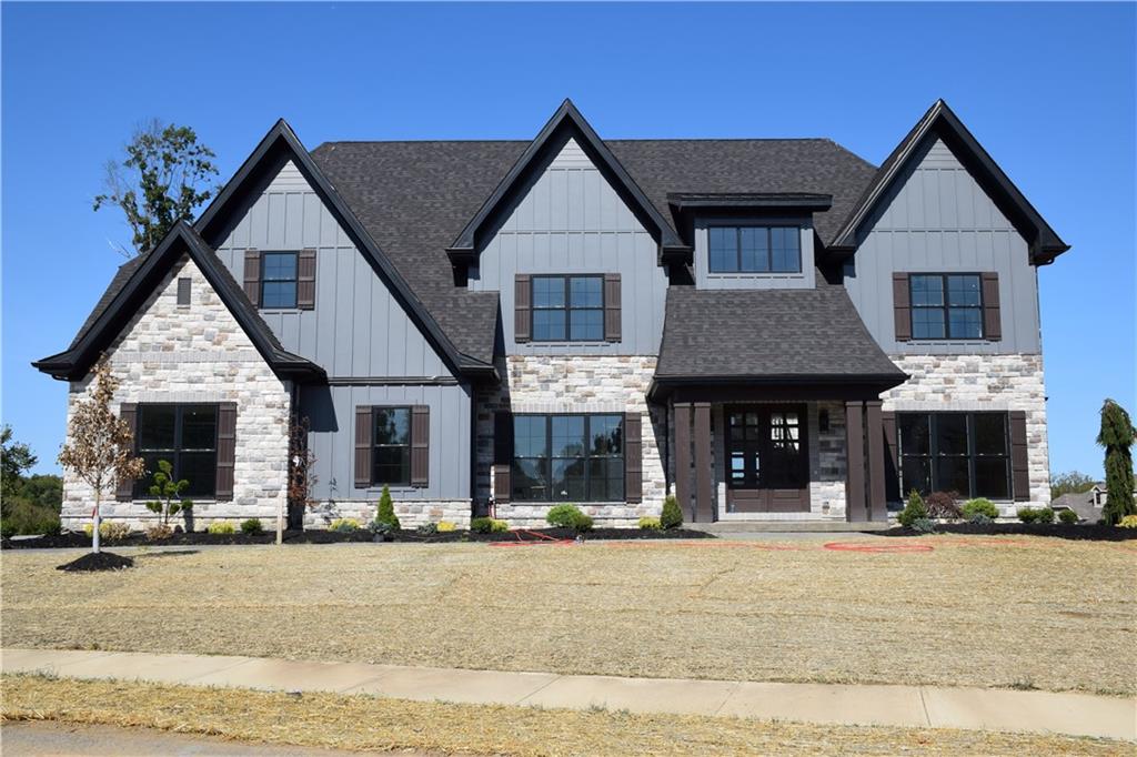 a front view of a house with that has a yard