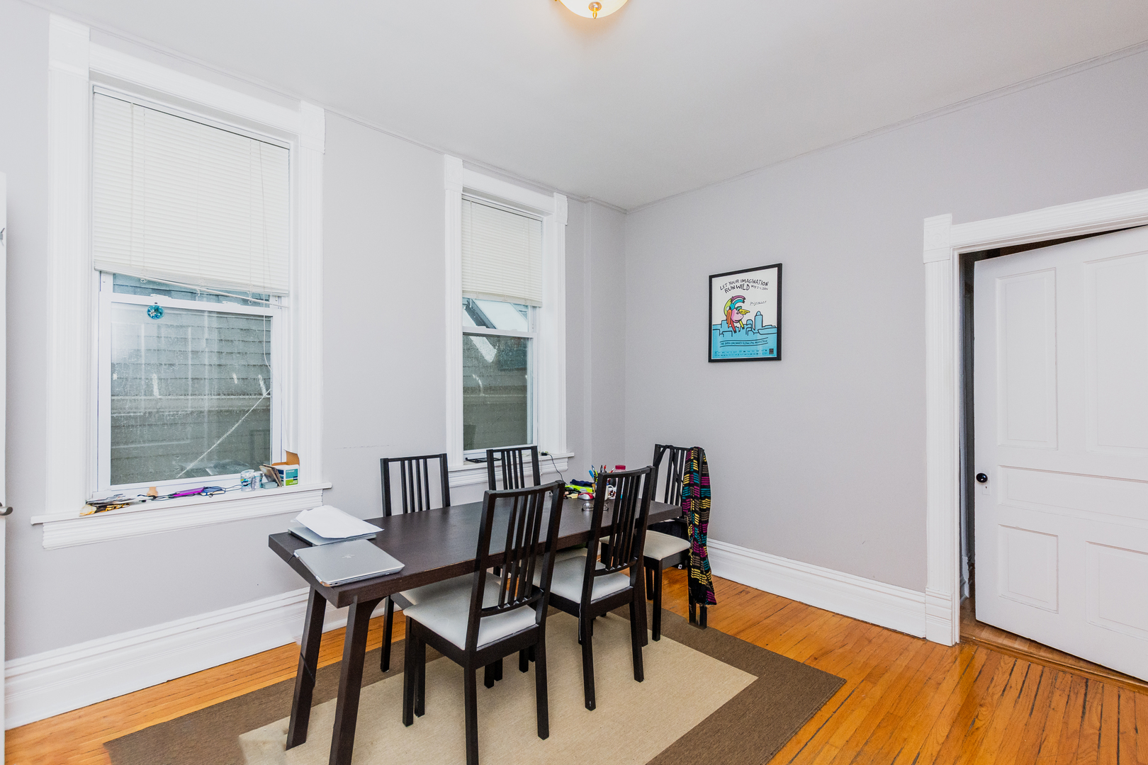 1645 West Irving Park Road Chicago, IL 60613 - Photo 13 of 33 a view of a dining room with furniture and wooden floor