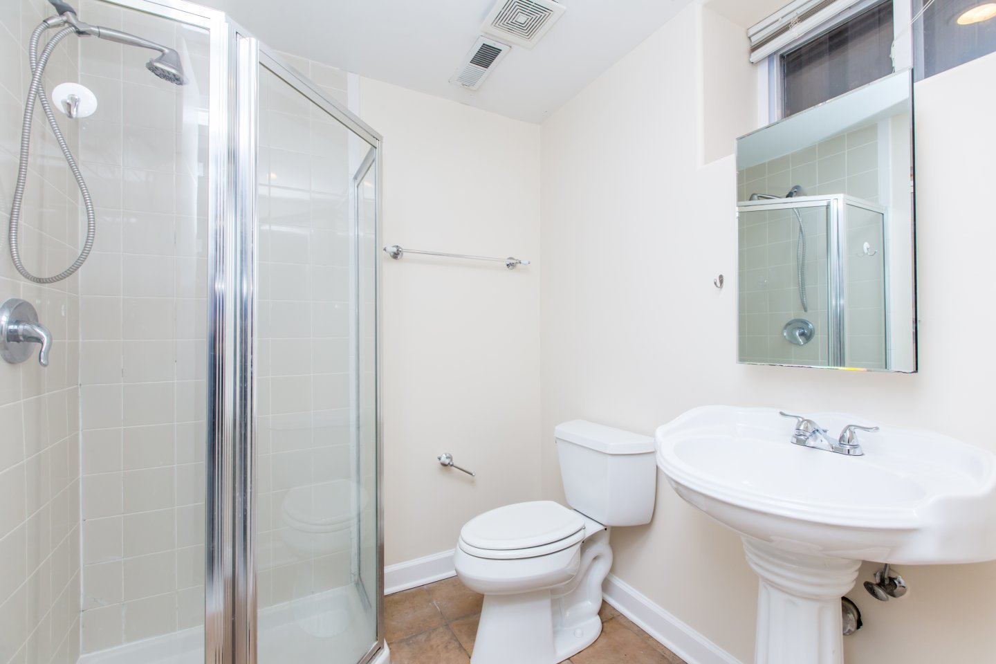 1645 West Irving Park Road Chicago, IL 60613 - Photo 22 of 33 a bathroom with a toilet sink shower and mirror