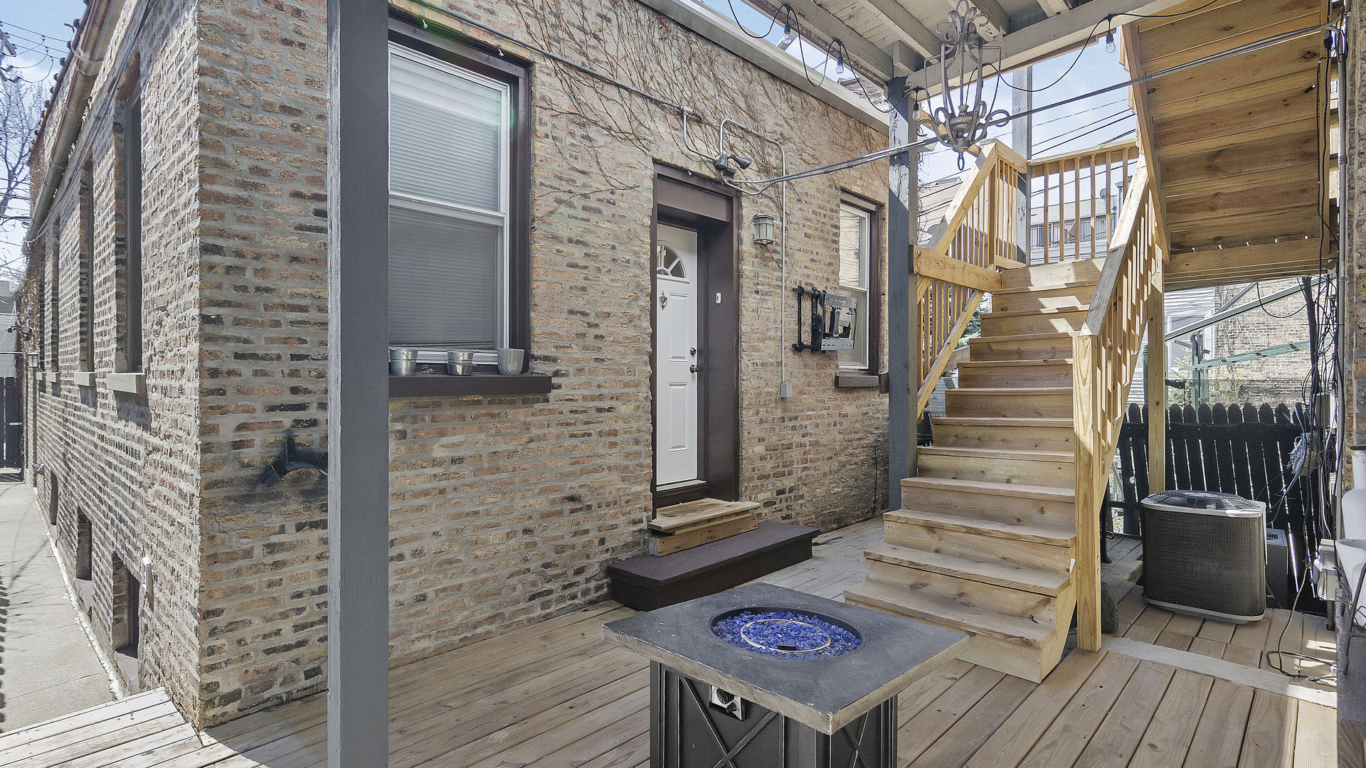 1645 West Irving Park Road Chicago, IL 60613 - Photo 25 of 33 a view of a balcony with wooden floor and stairs