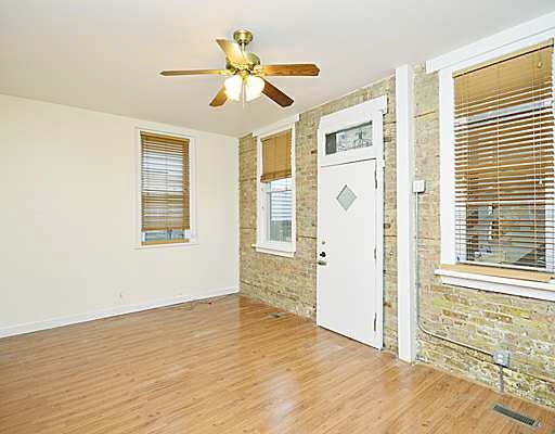 1645 West Irving Park Road Chicago, IL 60613 - Photo 5 of 33 a view of a livingroom with a ceiling fan and window