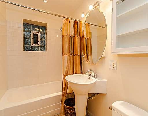 1645 West Irving Park Road Chicago, IL 60613 - Photo 7 of 33 a bathroom with a sink a toilet and shower