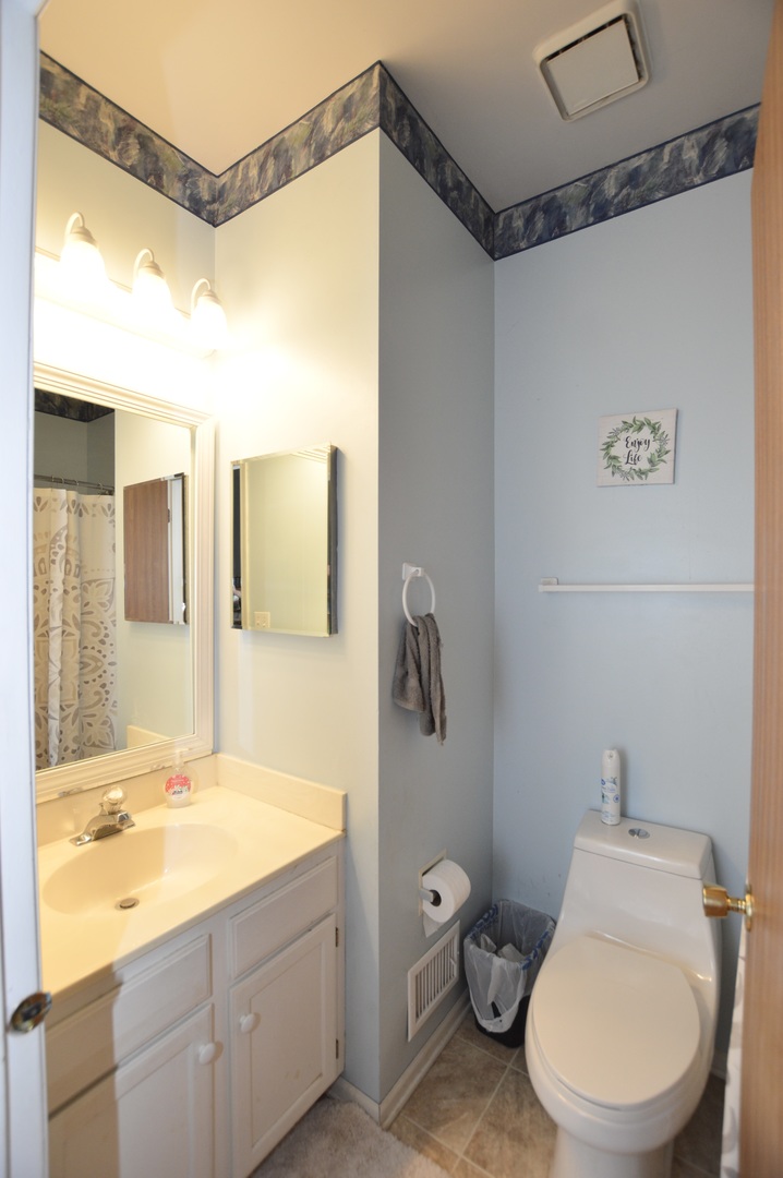 2001 Pine Drive McHenry, IL 60051 - Photo 16 of 19 a bathroom with a granite countertop toilet sink and mirror
