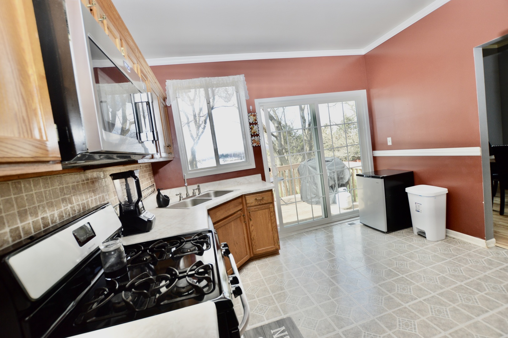 2001 Pine Drive McHenry, IL 60051 - Photo 5 of 19 a kitchen with stainless steel appliances granite countertop a stove a sink and a microwave