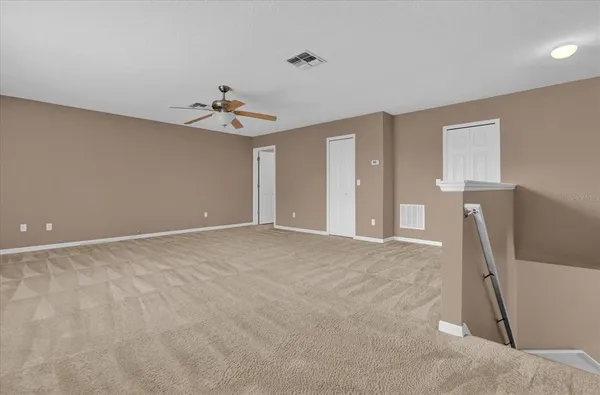 a view of a livingroom with furniture and a ceiling fan