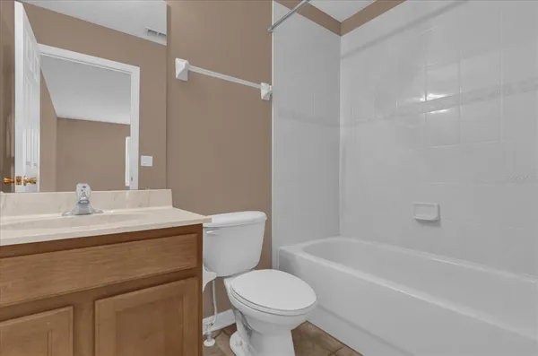 a bathroom with a sink toilet vanity and bathtub