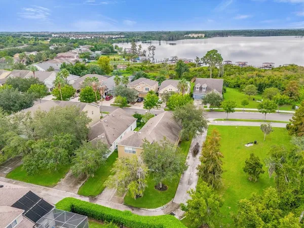 an aerial view of residential houses with outdoor space and swimming pool