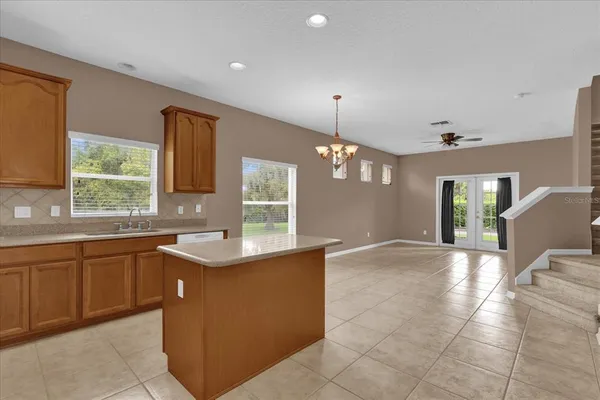 a kitchen with a sink and chandelier