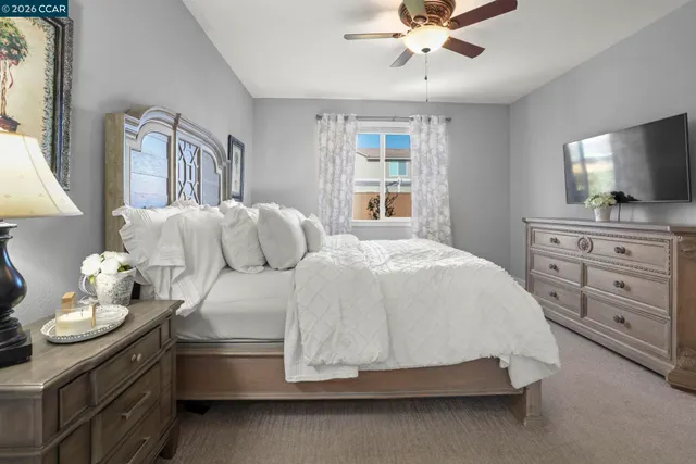 a spacious bedroom with a bed and window