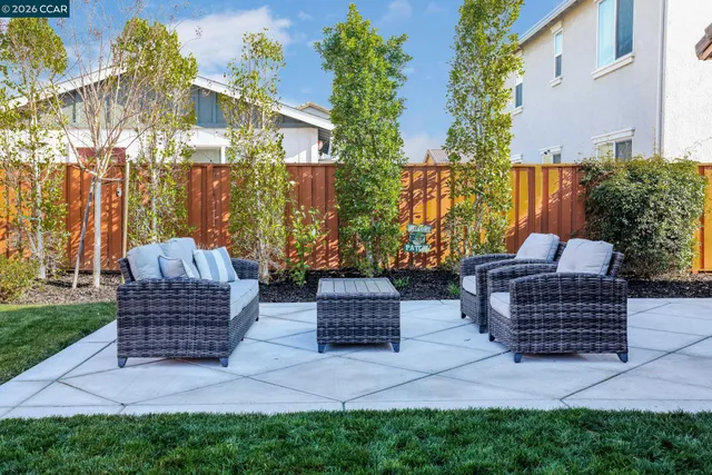 a view of house with backyard and outdoor seating