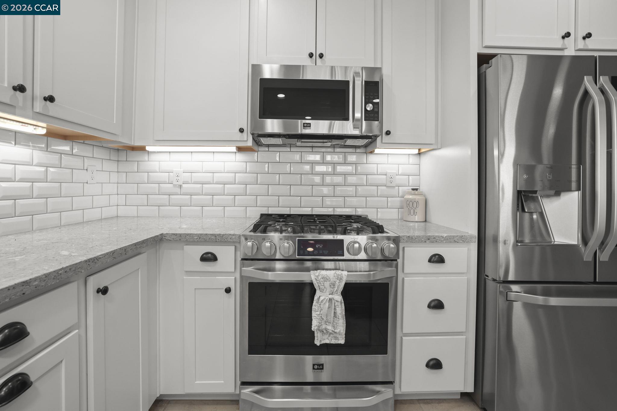 5245 Medea Way Antioch, CA 94531 - Photo 7 of 28 a kitchen with stainless steel appliances wooden cabinets and a stove top oven