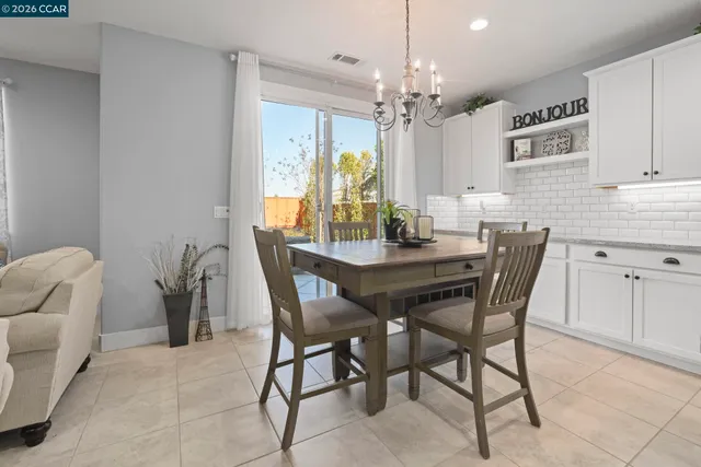 a view of a dining room with furniture and chandelier
