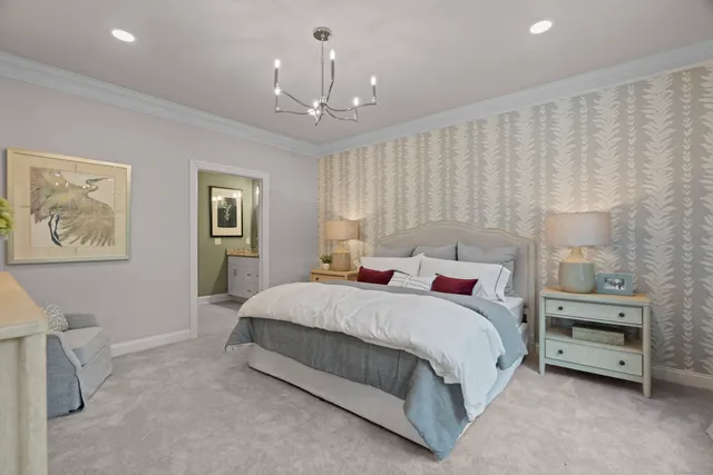 a bedroom with a large bed and a chandelier