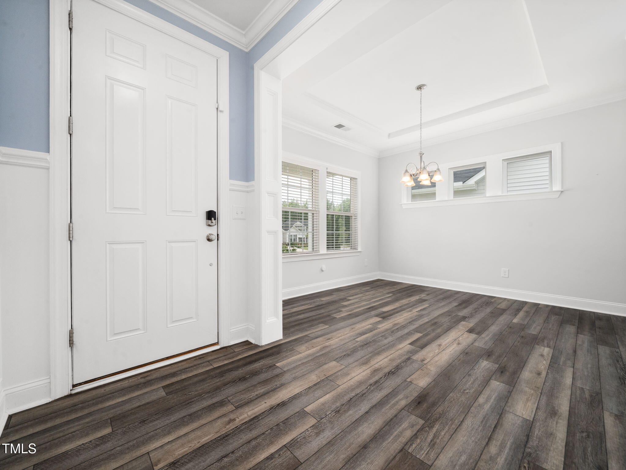 3213 Douglas Fir Road Raleigh, NC 27616 - Photo 13 of 44 an empty room with wooden floor and windows