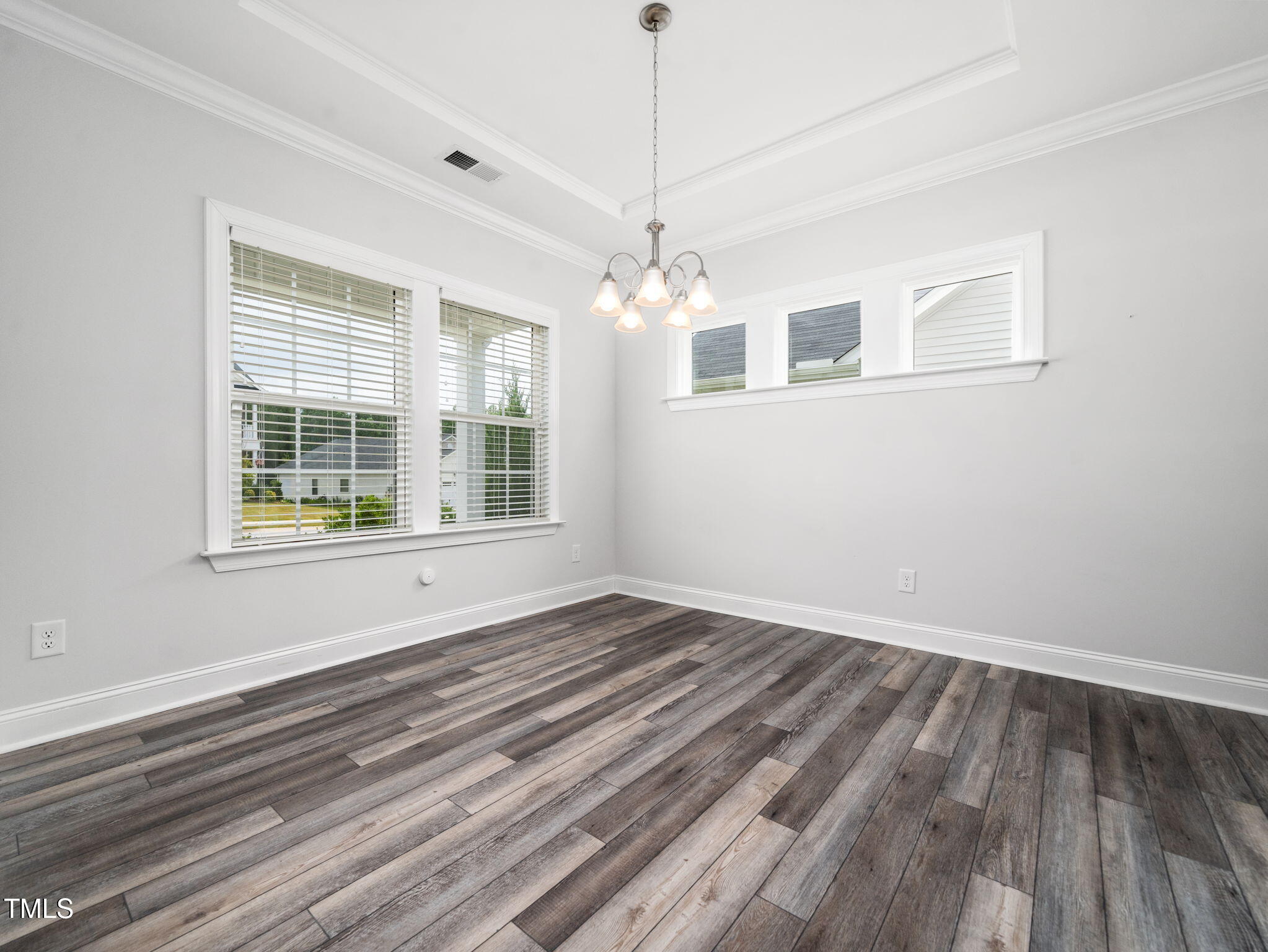 3213 Douglas Fir Road Raleigh, NC 27616 - Photo 14 of 44 a view of an empty room with wooden floor and a window