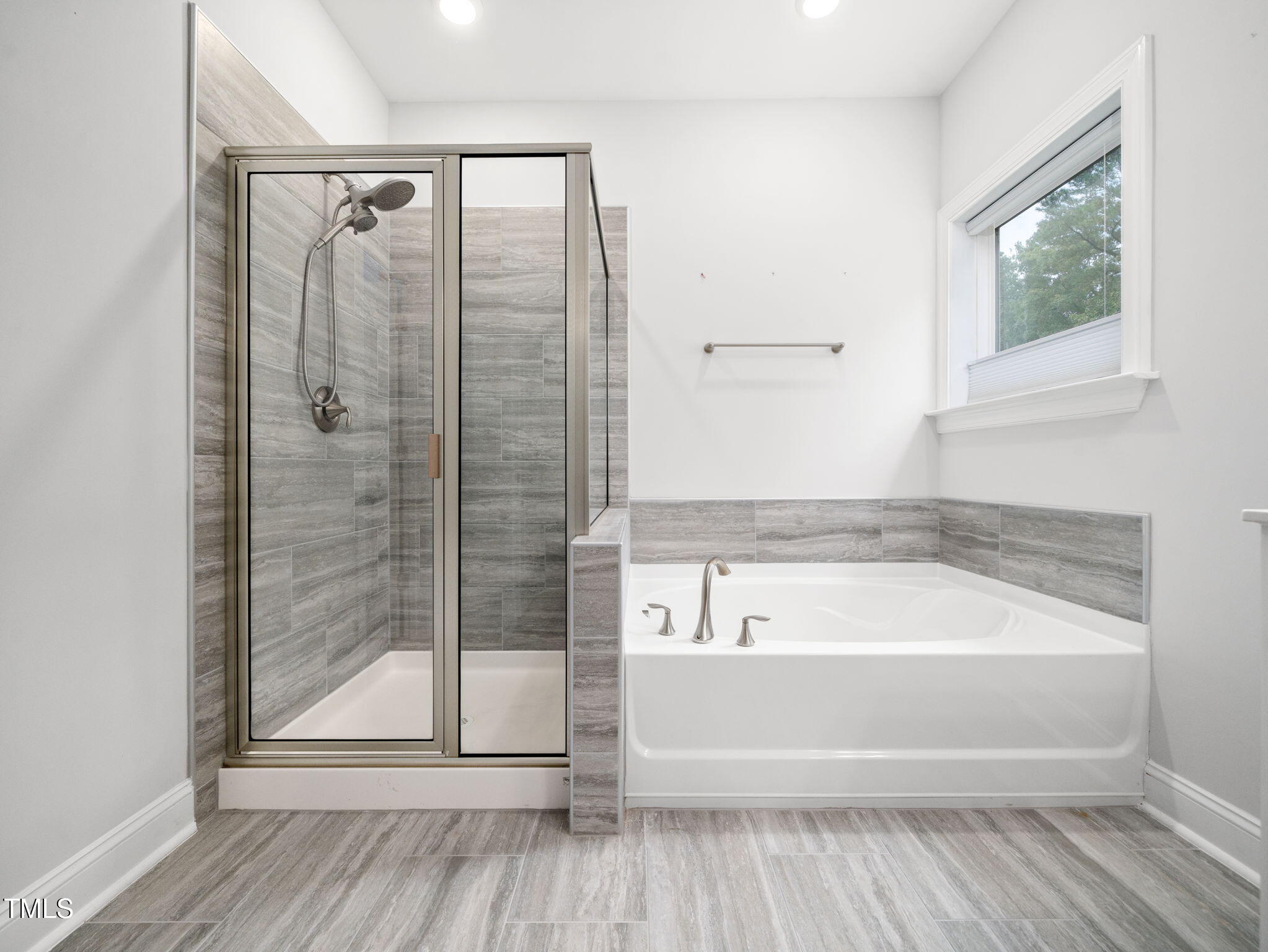 3213 Douglas Fir Road Raleigh, NC 27616 - Photo 21 of 44 a bathroom with a tub and shower