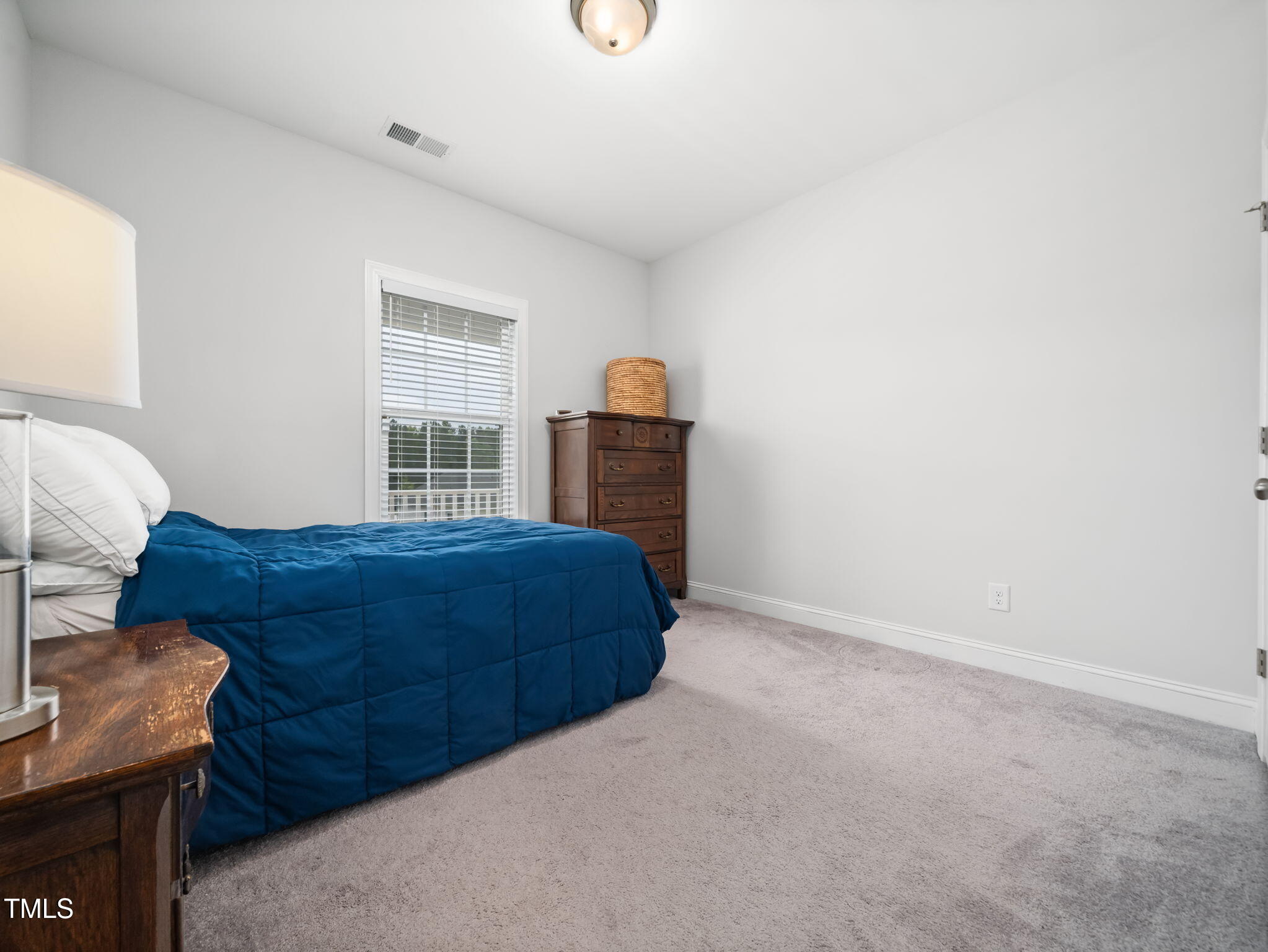 3213 Douglas Fir Road Raleigh, NC 27616 - Photo 25 of 44 a bedroom with a bed and a window