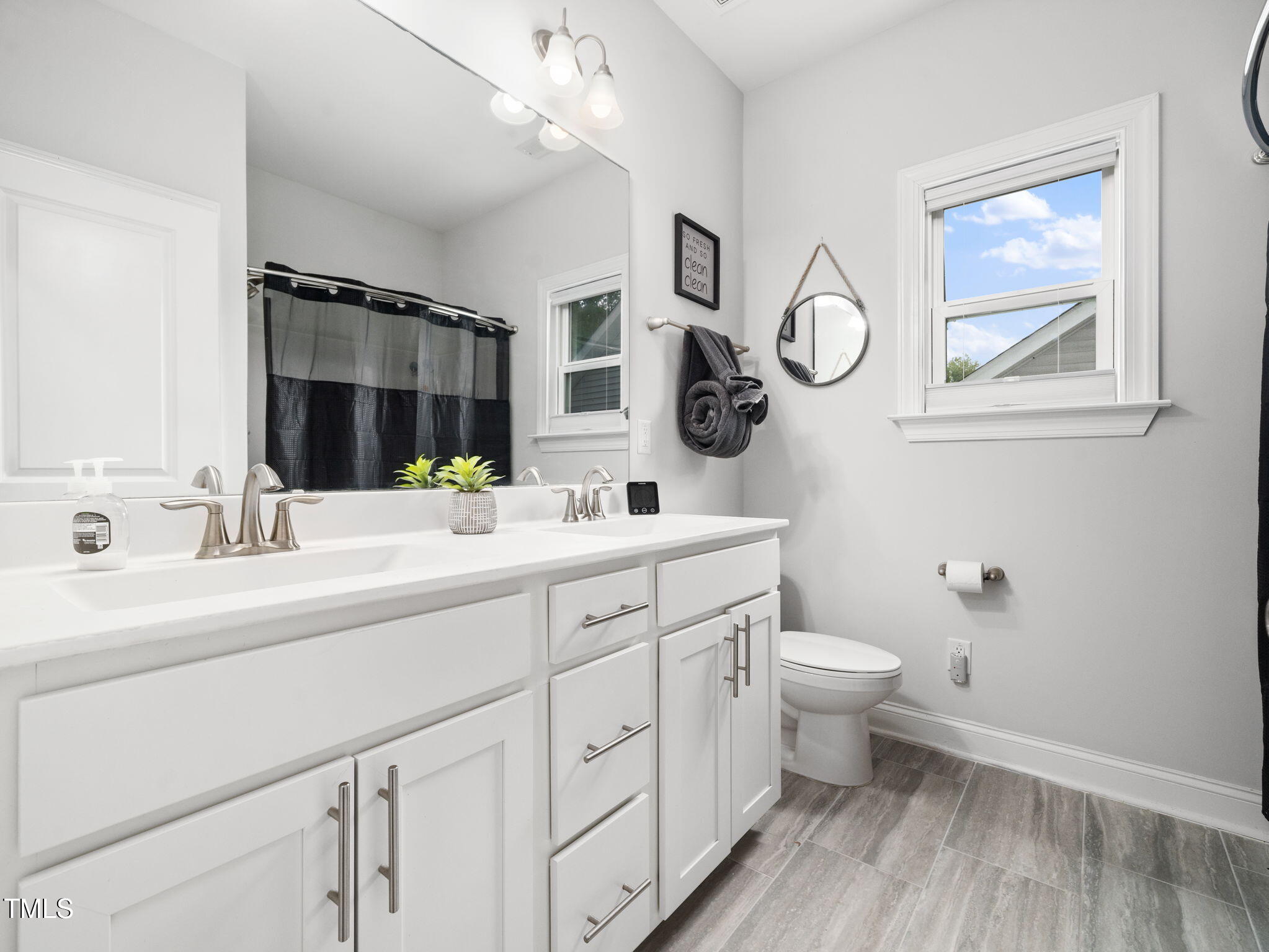 3213 Douglas Fir Road Raleigh, NC 27616 - Photo 26 of 44 a bathroom with a toilet a sink and mirror