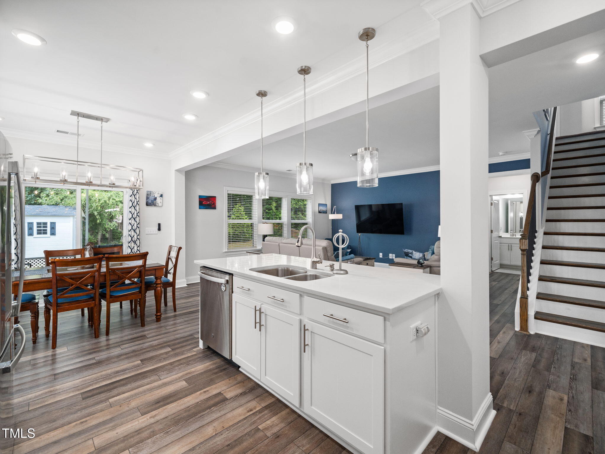 3213 Douglas Fir Road Raleigh, NC 27616 - Photo 5 of 44 a large kitchen with kitchen island a sink and a stove top oven