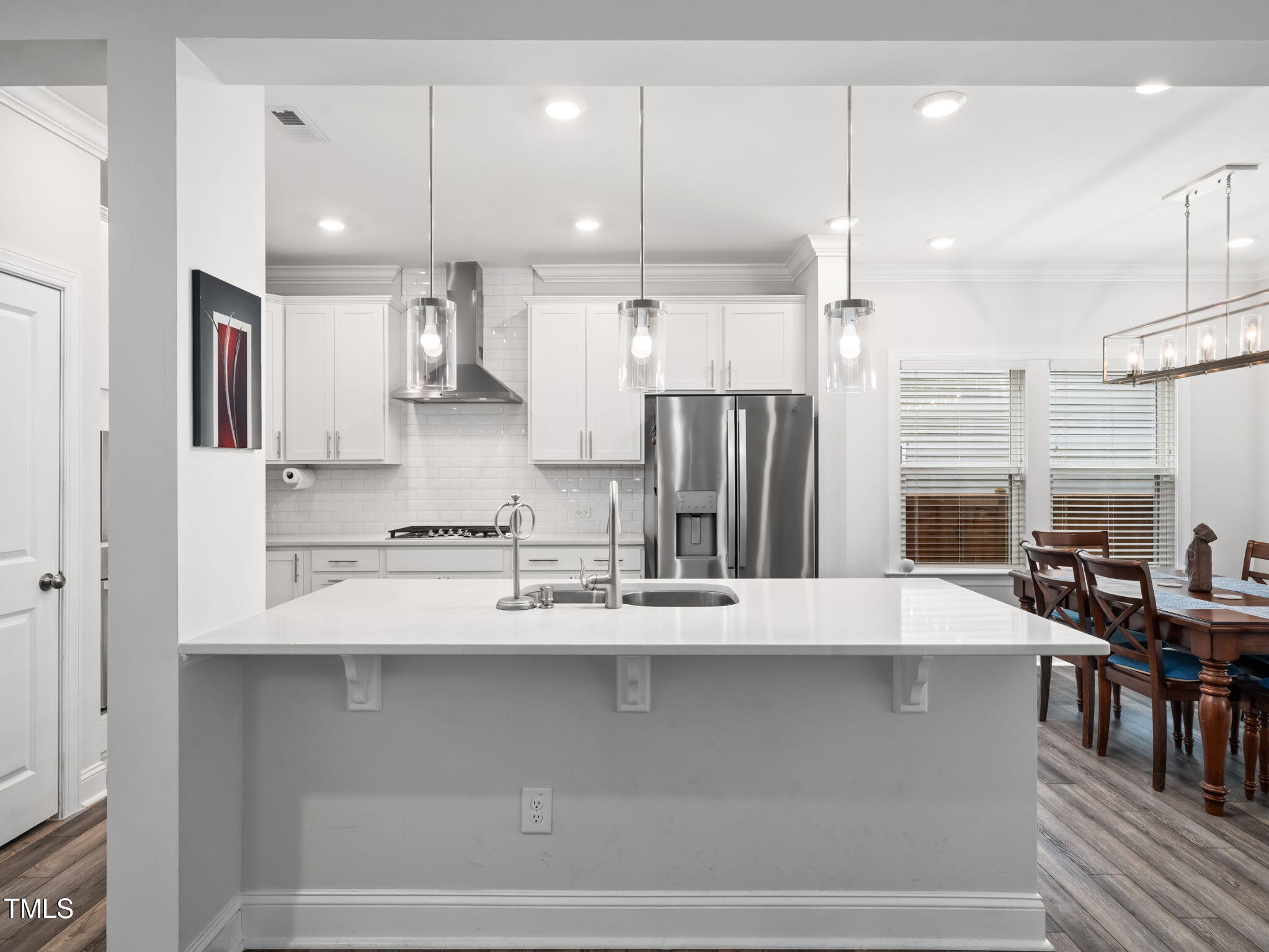 3213 Douglas Fir Road Raleigh, NC 27616 - Photo 7 of 44 a large kitchen with stainless steel appliances kitchen island a large island a stove and a refrigerator