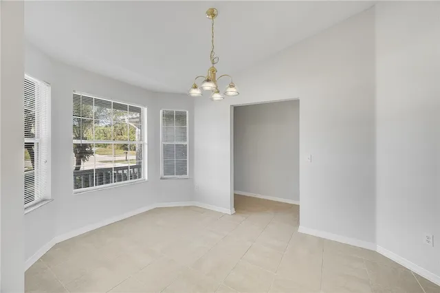 a view of a room with windows and chandelier