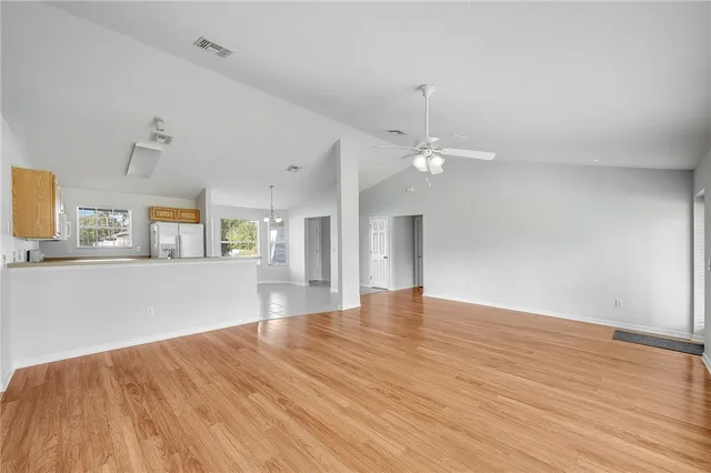 a view of a kitchen with wooden floor and a kitchen