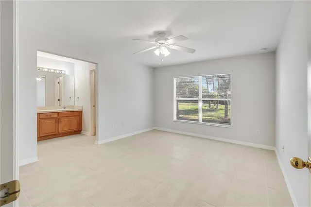 a view of a livingroom with a ceiling fan and window