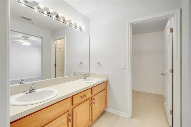 a bathroom with a double vanity sink and a mirror