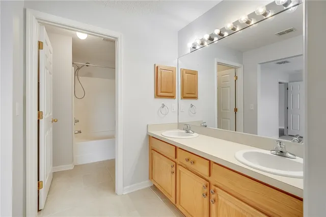 a spacious bathroom with a granite countertop sink and a mirror